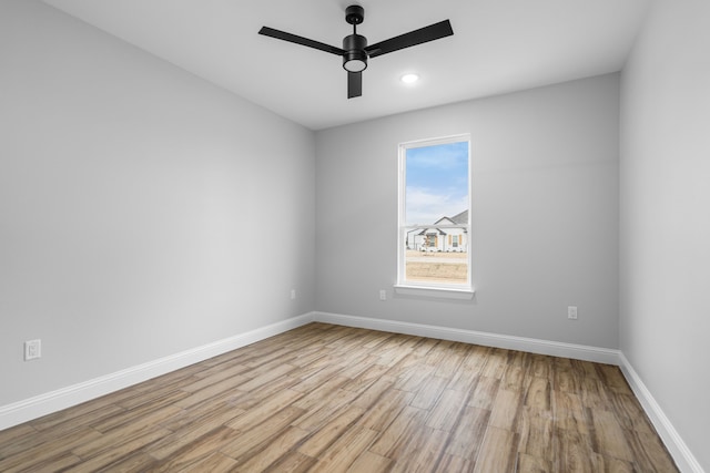 spare room with ceiling fan and light hardwood / wood-style floors