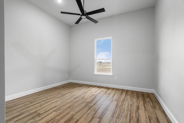 empty room with ceiling fan and light wood-type flooring