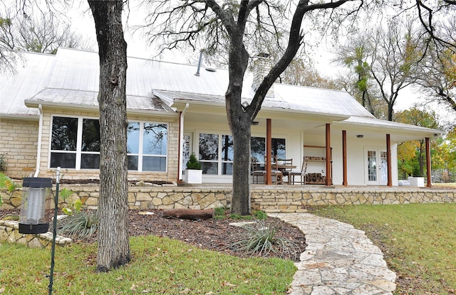 view of front of house with a front yard and a porch