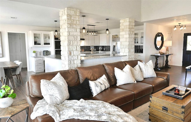 living room featuring hardwood / wood-style flooring and ornate columns