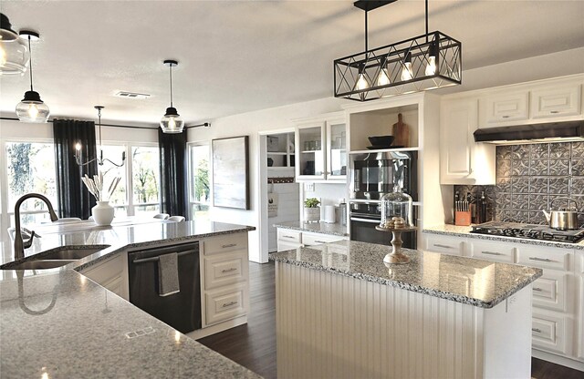 kitchen featuring white cabinets, sink, light stone counters, and black appliances