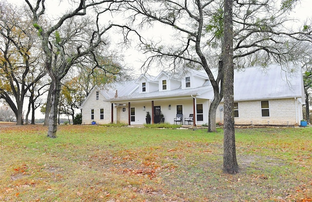 cape cod-style house featuring a front yard