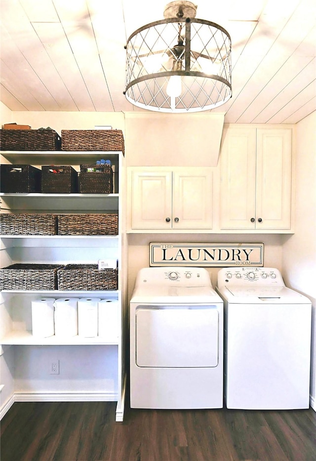 laundry room featuring cabinets, dark hardwood / wood-style flooring, washer and dryer, and wood ceiling