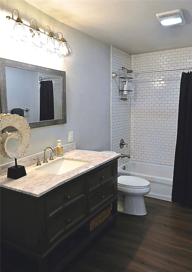 full bathroom featuring vanity, hardwood / wood-style flooring, toilet, and shower / bath combo with shower curtain