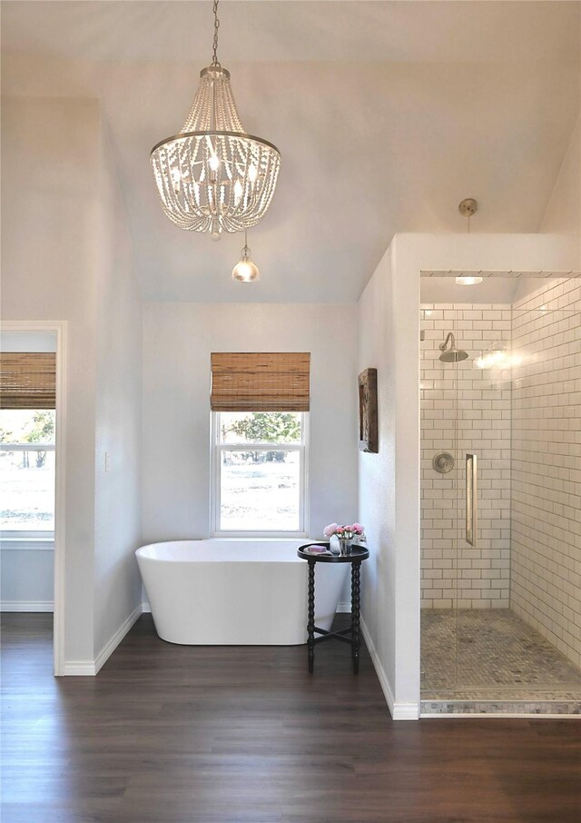 bathroom with hardwood / wood-style flooring, independent shower and bath, and a chandelier