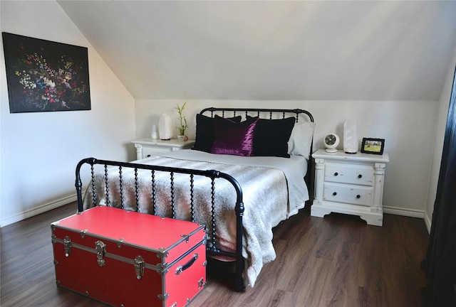 bedroom featuring lofted ceiling and dark wood-type flooring