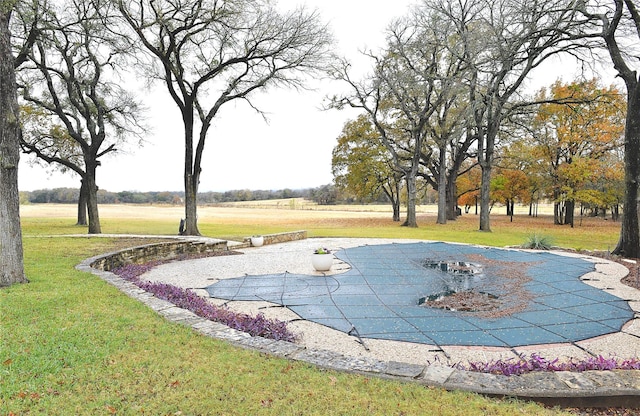 view of property's community with a patio area and a yard