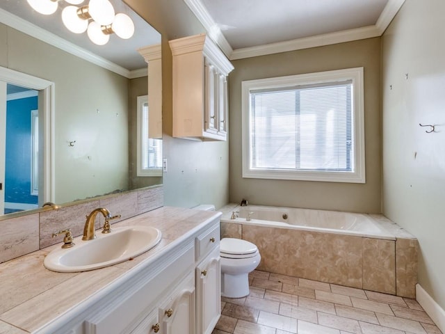 bathroom featuring ornamental molding, vanity, toilet, and tiled tub