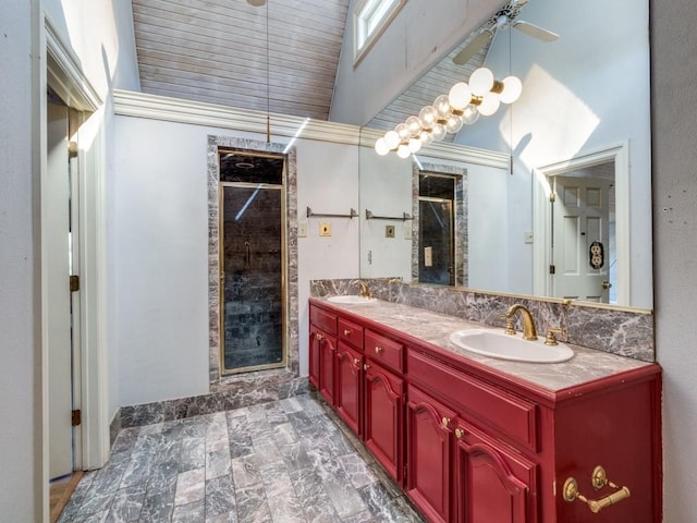 bathroom featuring a shower with door and vanity