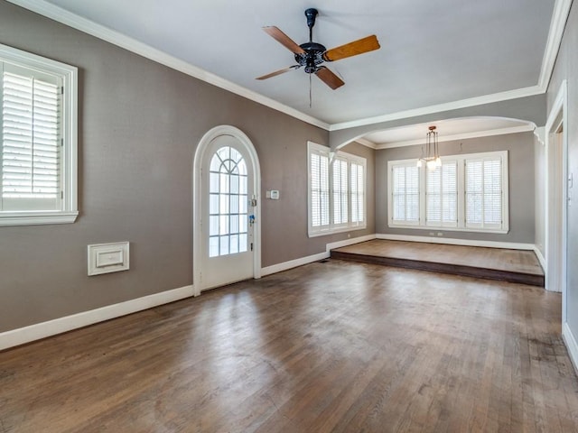 foyer featuring crown molding, a wealth of natural light, and hardwood / wood-style floors