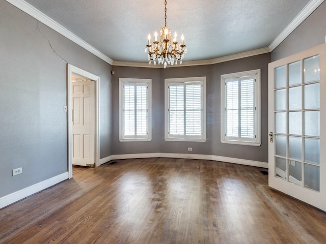 unfurnished dining area with dark hardwood / wood-style flooring, crown molding, and a textured ceiling