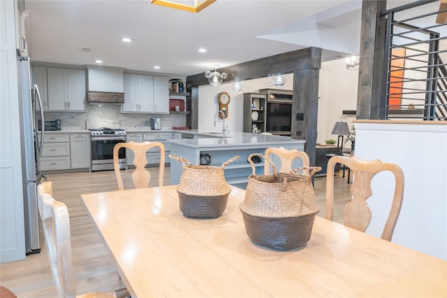 dining room with light hardwood / wood-style flooring and sink