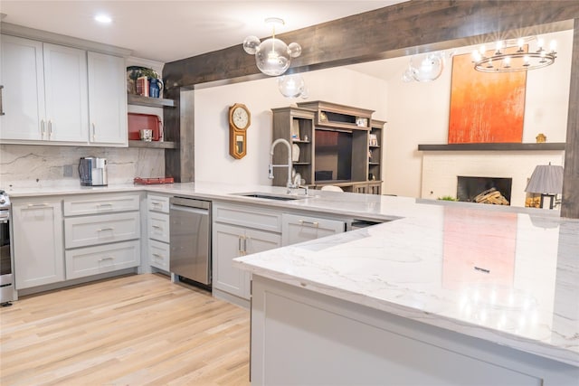 kitchen featuring tasteful backsplash, sink, pendant lighting, and appliances with stainless steel finishes