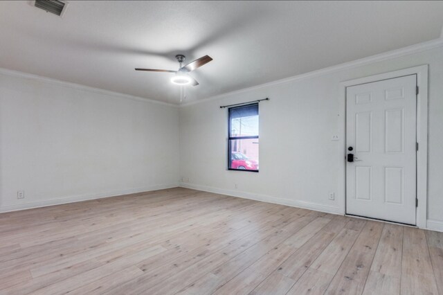 empty room featuring ceiling fan, light hardwood / wood-style floors, and ornamental molding