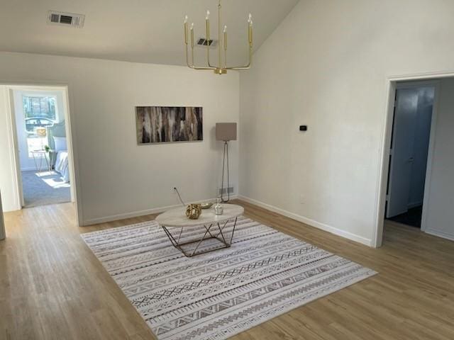 sitting room featuring wood-type flooring and an inviting chandelier