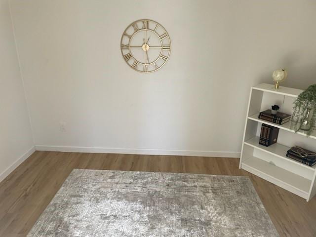 unfurnished room with hardwood / wood-style flooring