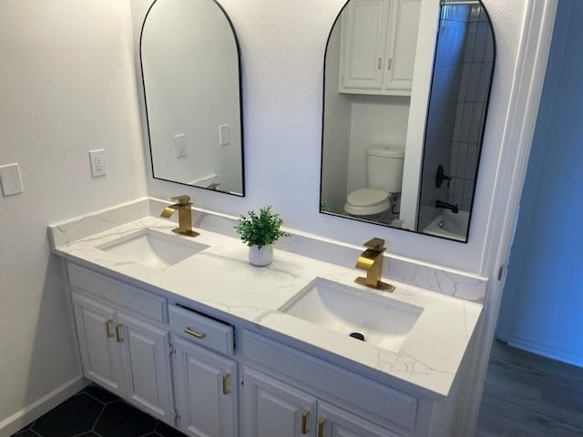 bathroom with tile patterned floors, vanity, and toilet