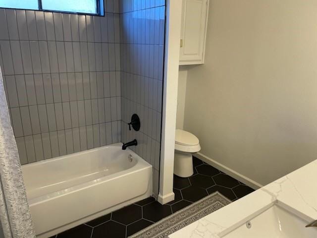 full bathroom featuring tile patterned flooring, vanity, shower / bath combo, and toilet