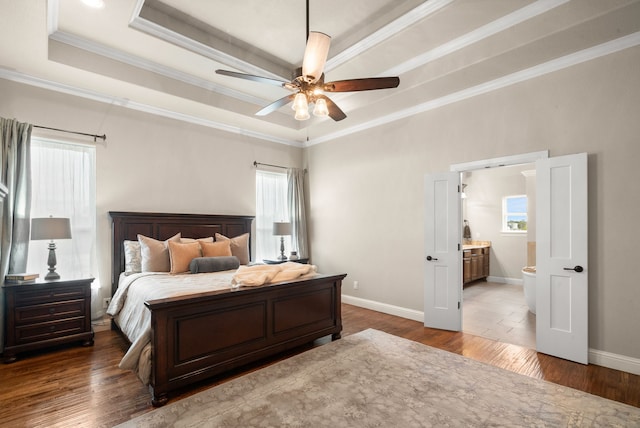 bedroom featuring hardwood / wood-style floors, ceiling fan, crown molding, and a tray ceiling