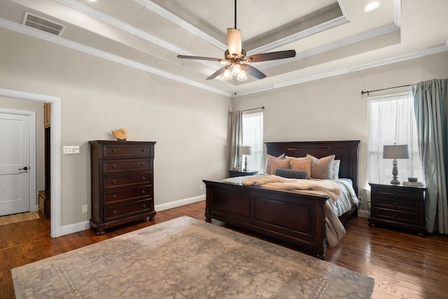 bedroom with a raised ceiling, ceiling fan, dark hardwood / wood-style flooring, and ornamental molding