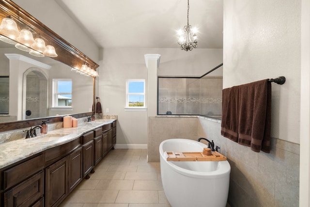 bathroom featuring tile patterned flooring, vanity, independent shower and bath, and a notable chandelier