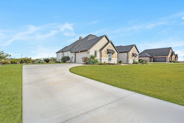 french provincial home featuring a garage and a front yard