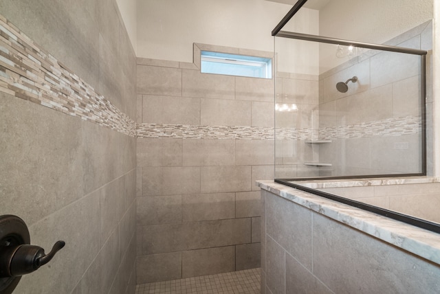 bathroom with a tile shower