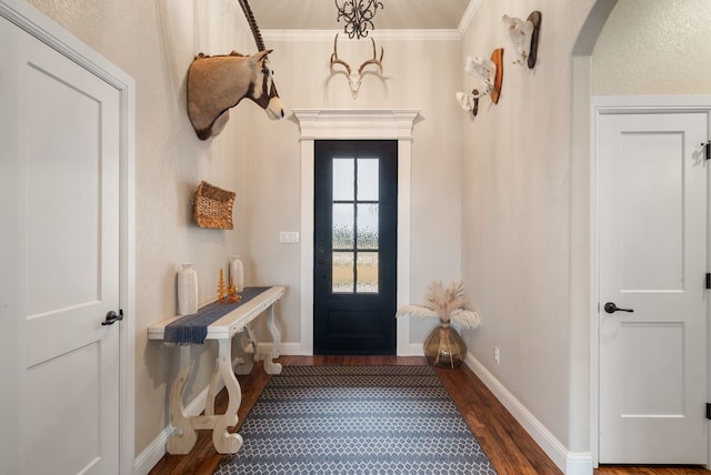 mudroom with dark hardwood / wood-style flooring and ornamental molding