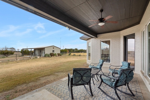 view of patio featuring ceiling fan