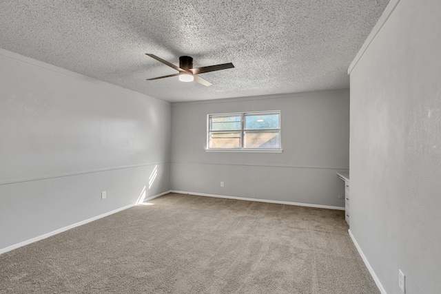 carpeted spare room featuring a textured ceiling and ceiling fan