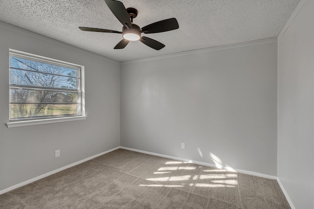 empty room with ceiling fan, light colored carpet, and a textured ceiling