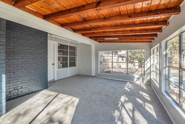 unfurnished sunroom featuring beamed ceiling and wooden ceiling