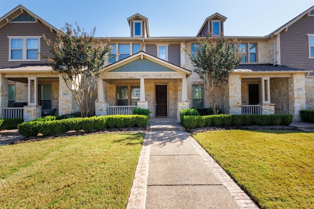 view of front of house with a front yard and covered porch