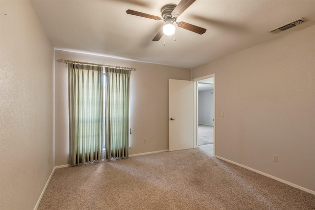 unfurnished room featuring light carpet and ceiling fan