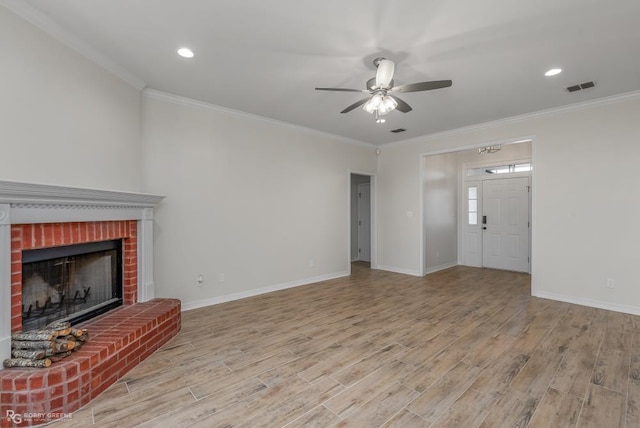 living room featuring a fireplace, ornamental molding, ceiling fan, and light wood-type flooring