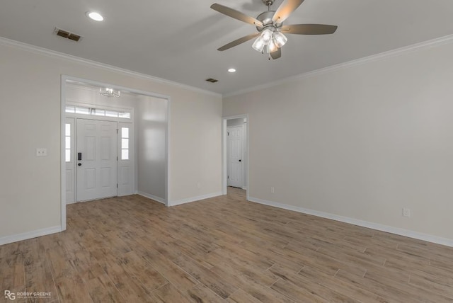 foyer entrance featuring crown molding, ceiling fan with notable chandelier, and light hardwood / wood-style floors