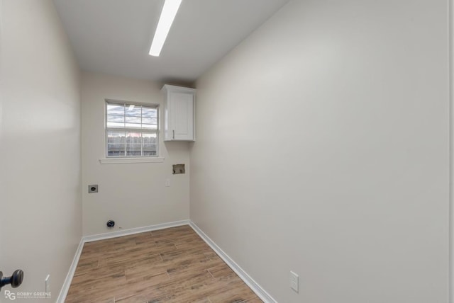 laundry area with cabinets, hookup for an electric dryer, hookup for a washing machine, and light hardwood / wood-style floors