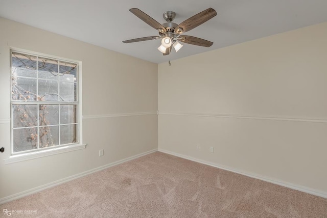 carpeted empty room featuring ceiling fan