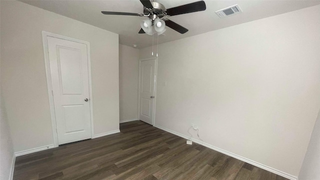 unfurnished bedroom with ceiling fan and dark hardwood / wood-style flooring