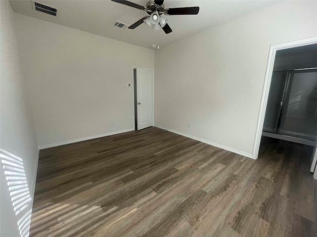 spare room featuring ceiling fan and dark hardwood / wood-style flooring