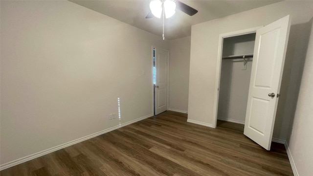 unfurnished bedroom with ceiling fan, dark hardwood / wood-style flooring, and a closet