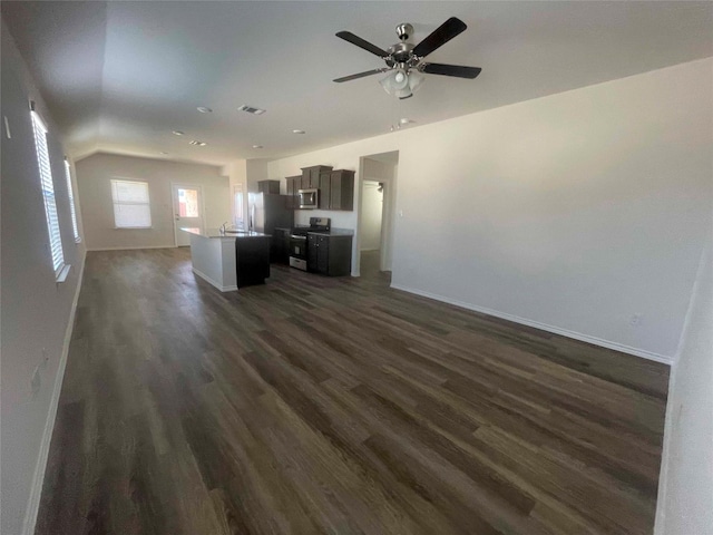 kitchen with an island with sink, ceiling fan, dark hardwood / wood-style floors, and stainless steel appliances