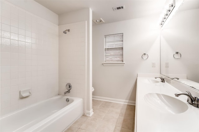 full bathroom with vanity, tile patterned floors, toilet, and tiled shower / bath