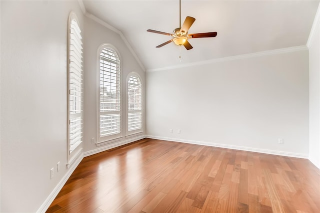 empty room with vaulted ceiling, ornamental molding, ceiling fan, and light wood-type flooring