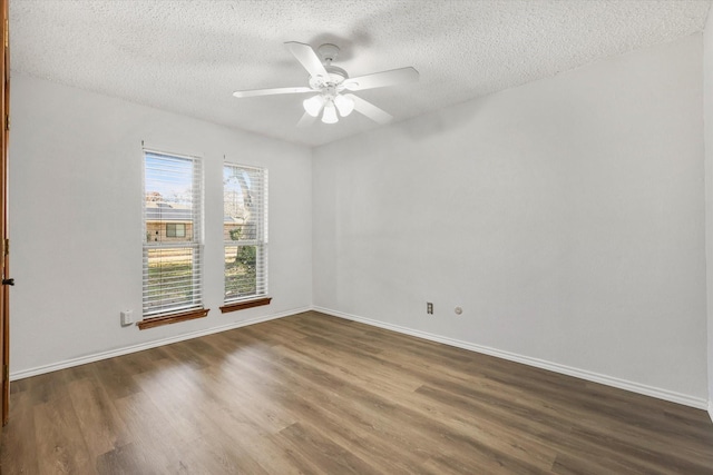 spare room with ceiling fan, dark hardwood / wood-style flooring, and a textured ceiling