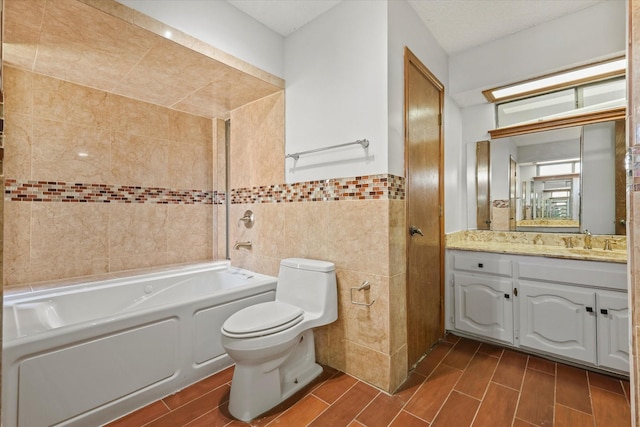 bathroom featuring vanity, toilet, and tile walls