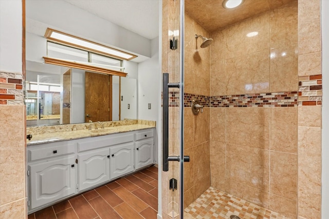 bathroom featuring vanity and an enclosed shower