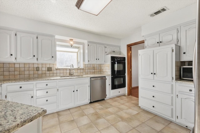 kitchen with dishwasher, backsplash, white cabinets, sink, and black double oven