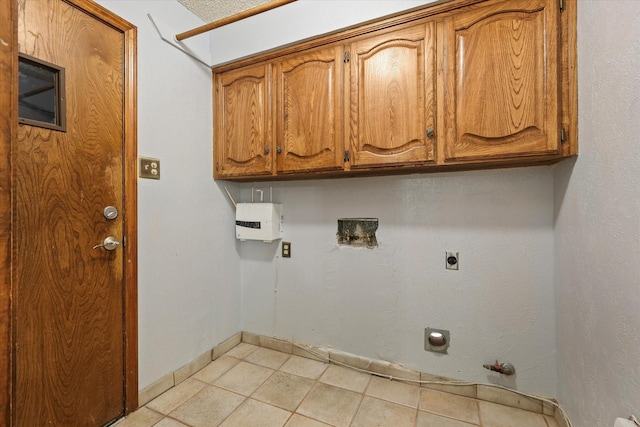 laundry room with electric dryer hookup, gas dryer hookup, cabinets, and washer hookup