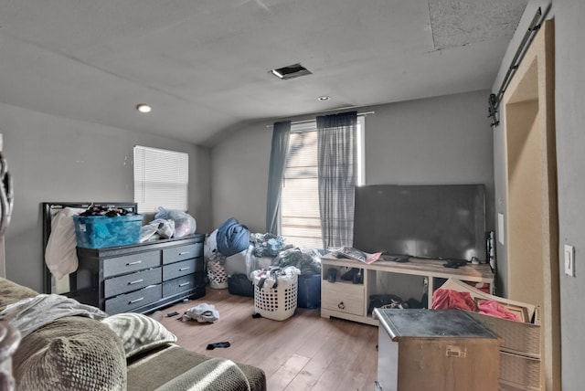 living room with light hardwood / wood-style flooring and vaulted ceiling